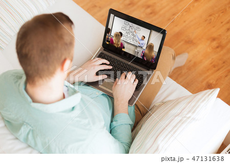 man watching webinar on laptop computer at home man watching webinar on laptop computer at home 47131638