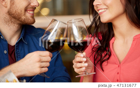happy couple drinking red wine at restaurant happy couple drinking red wine at restaurant 47131677