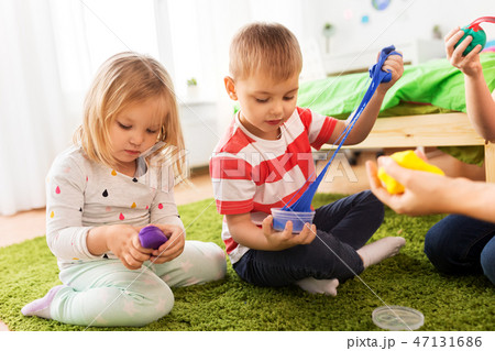 children with modelling clay or slimes at home 47131686