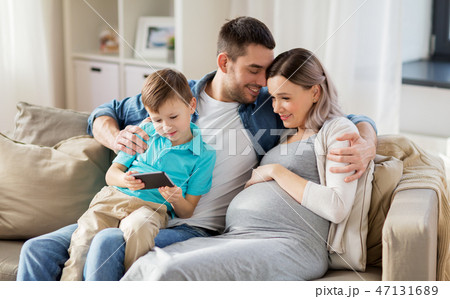 happy family with smartphone at home 47131689
