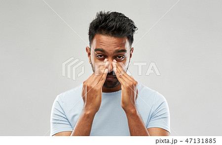 indian man rubbing nose indian man rubbing nose 47131885