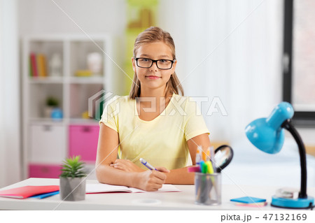 happy student girl doing homework at home 47132169