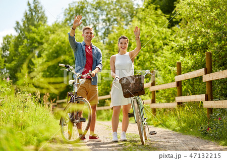 happy couple with bicycles at summer park happy couple with bicycles at summer park 47132215