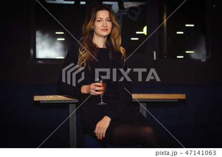 Pretty girl in bar spending time, having cocktail Pretty girl in bar spending time, having cocktail 47141063