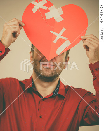 Adult man holding broken heart Adult man holding broken heart 47143338