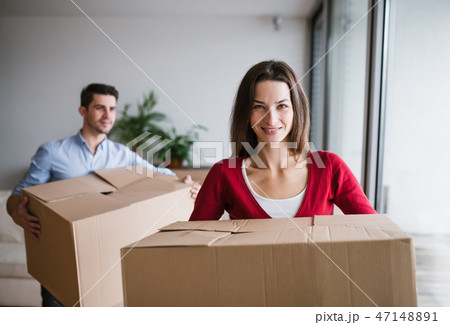 Young couple with cardboard boxes moving in a new home. Young couple with cardboard boxes moving in a new home. 47148891