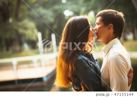 Beautiful young couple on the lake background Beautiful young couple on the lake background 47155144