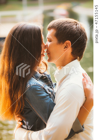 Beautiful young couple on the lake background 47155145