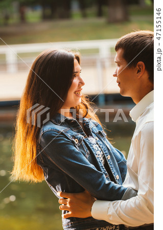 Beautiful young couple on the lake background 47155146