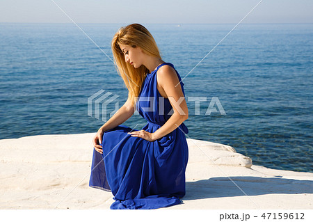 Blond woman in blue Blond woman in blue 47159612