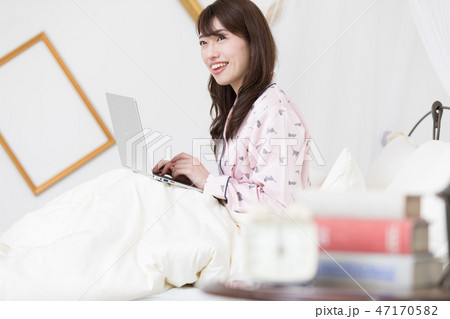 ベッドでパソコンをする女性 ベッドでパソコンをする女性 47170582