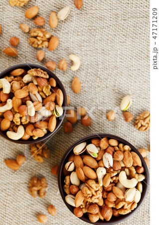 Mix of various nuts in a wooden cup against  47171209