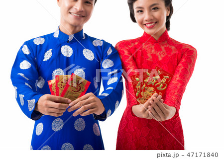 Cheerful Asian couple celebrating Lunar Year Cheerful Asian couple celebrating Lunar Year 47171840