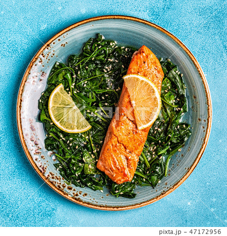 Grilled salmon with spinach. 47172956