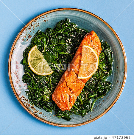 Grilled salmon with spinach. 47172962