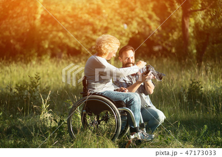Disabled woman look on the taken photos on camera. 47173033