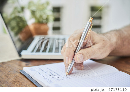 Aged man filling diary Aged man filling diary 47173110