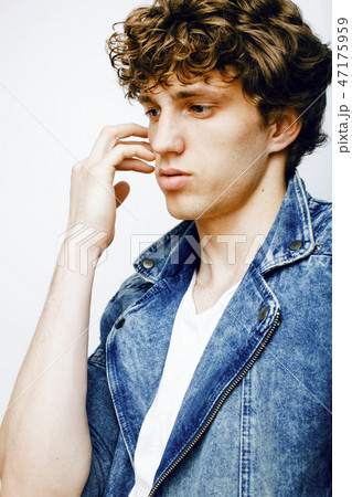 Portrait of a smart serious young man standing against white bac 47175959