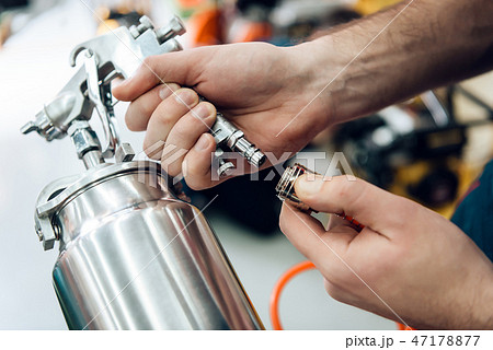 Close up. Salesman is posing with compressor paint 47178877
