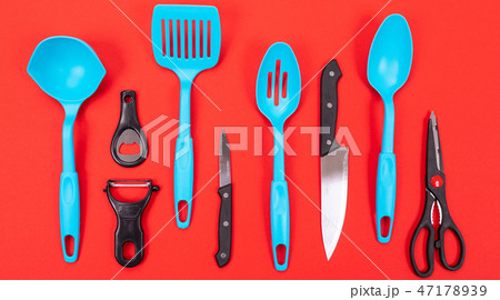 Cooking utensils in kitchen isolated on red background Cooking utensils in kitchen isolated on red background 47178939