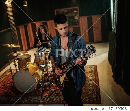 Music band having rehearsal in a studio 47179508