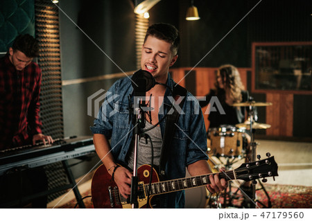 Music band having rehearsal in a studio 47179560