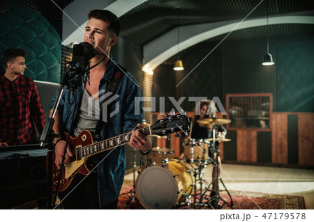 Music band having rehearsal in a studio Music band having rehearsal in a studio 47179578
