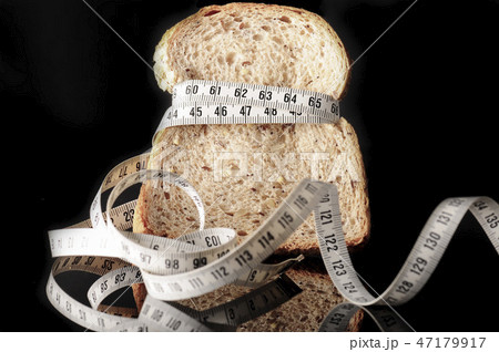 slice of bread surrounded by a measurement tape slice of bread surrounded by a measurement tape 47179917