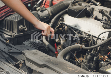 Beautiful girl hands open the car skirt to check  47182493
