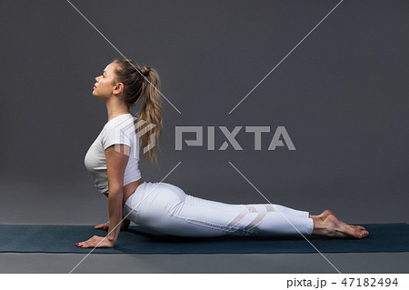 Sporty young woman doing yoga practice on black background. Sporty young woman doing yoga practice on black background. 47182494