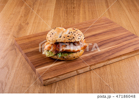 Sandwich with chicken fillet on a wooden board Sandwich with chicken fillet on a wooden board 47186048