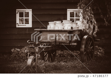 old traditional Dutch cans in a carriage in village 47186377