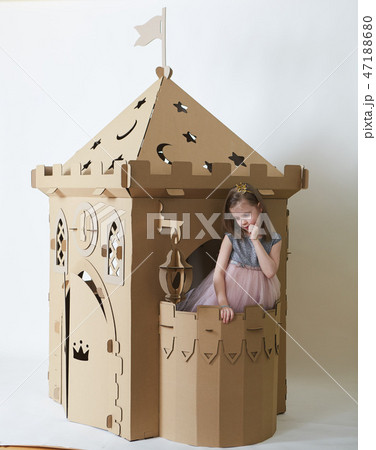 Beautiful little girl in princess dress playing with her toy castle. 47188680