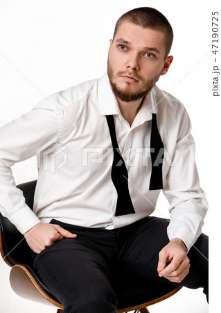 young bearded man in a white shirt and bow tie 47190725
