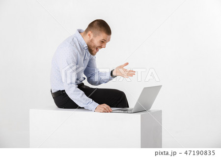 young handsome man in shirt and tie using laptop young handsome man in shirt and tie using laptop 47190835