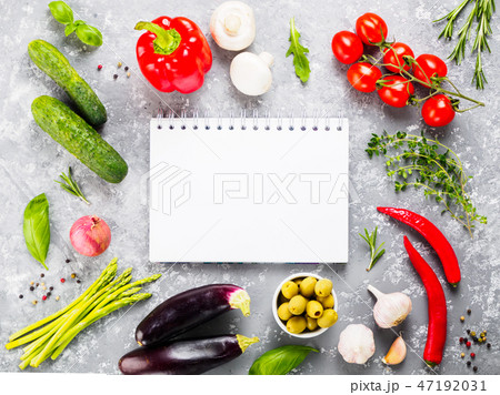 Notebook with vegetables and herbs on gray concrete background Notebook with vegetables and herbs on gray concrete background 47192031