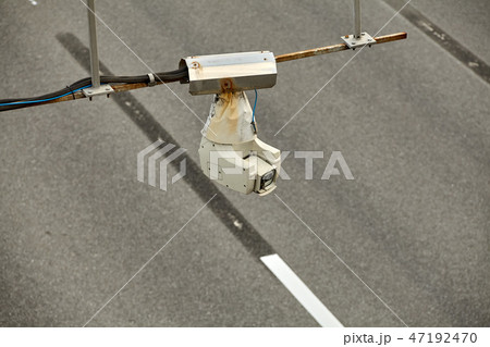 Security camera operating over the road, daytime. Security camera operating over the road, daytime. 47192470