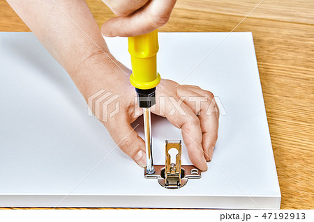 tightening in furniture door hinges by assembler tightening in furniture door hinges by assembler 47192913