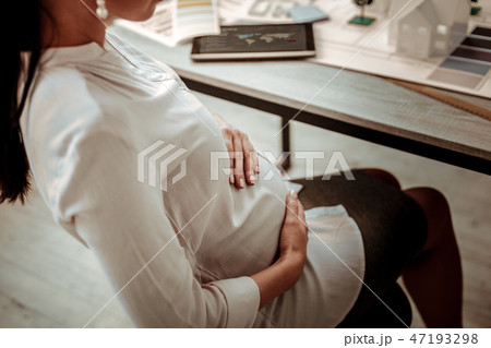 Pleasant nice woman sitting in the chair Pleasant nice woman sitting in the chair 47193298