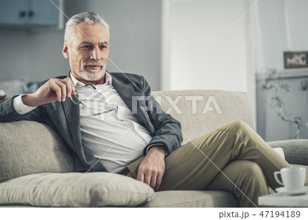 Man in grey jacket feeling thoughtful 47194189