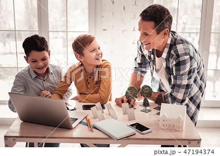 Father feeling involved in telling his sons about solar energy 47194374