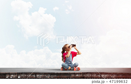Concept of careless happy childhood with girl of school age looking in future Concept of careless happy childhood with girl of school age looking in future 47199632