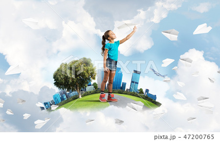 Concept of careless happy childhood with girl dreaming about future 47200765