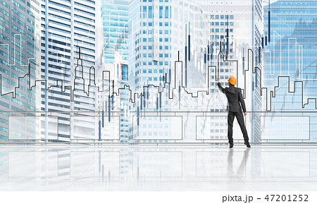 Sunrise above skyscrapers and engineer in helmet drawing globalization concept 47201252
