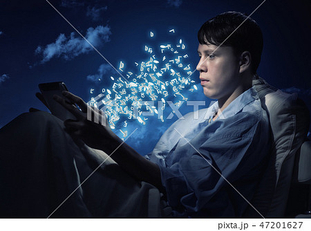 Reading in bed 47201627