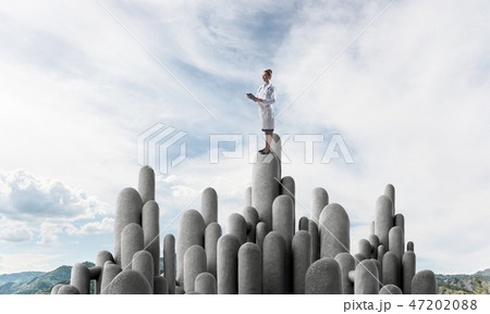 Medicine specialist or practitioner outdoors standing on top 47202088