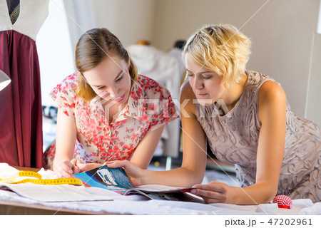 Two sempstress at work 47202961