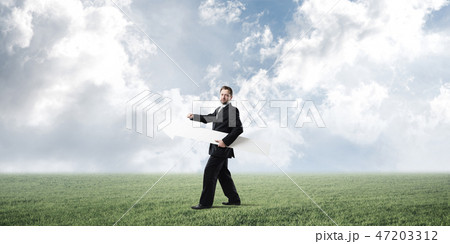 Conceptual image of businessman pointing aside Conceptual image of businessman pointing aside 47203312
