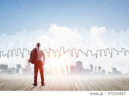 Motivation and inspiration concept with modern cityscape and businessman observing it Motivation and inspiration concept with modern cityscape and businessman observing it 47203887