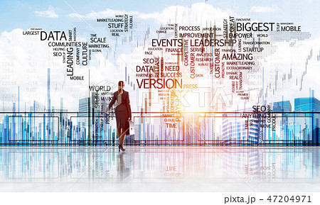 Sunrise above skyscrapers and businesswoman facing new day 47204971